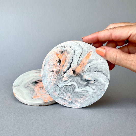 Pair of Jesmonite coasters in marble effect with neon highlights