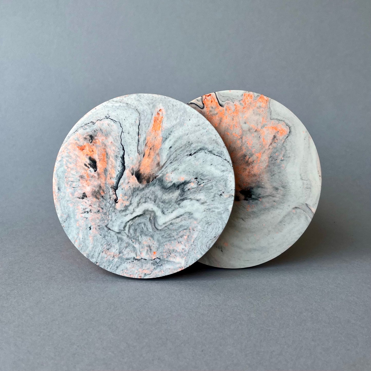 Pair of Jesmonite coasters in marble effect with neon highlights