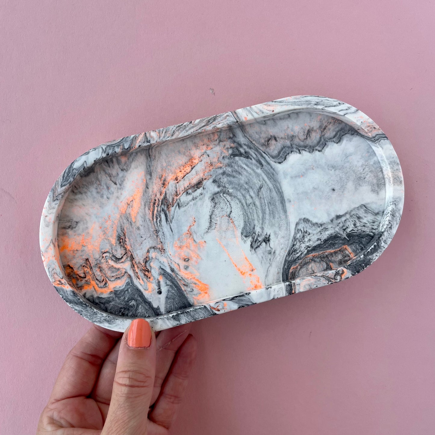 Oval trinket tray in marble effect with neon highlights